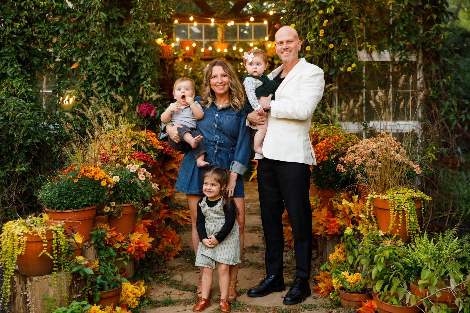 Parents pose with their children in a garden