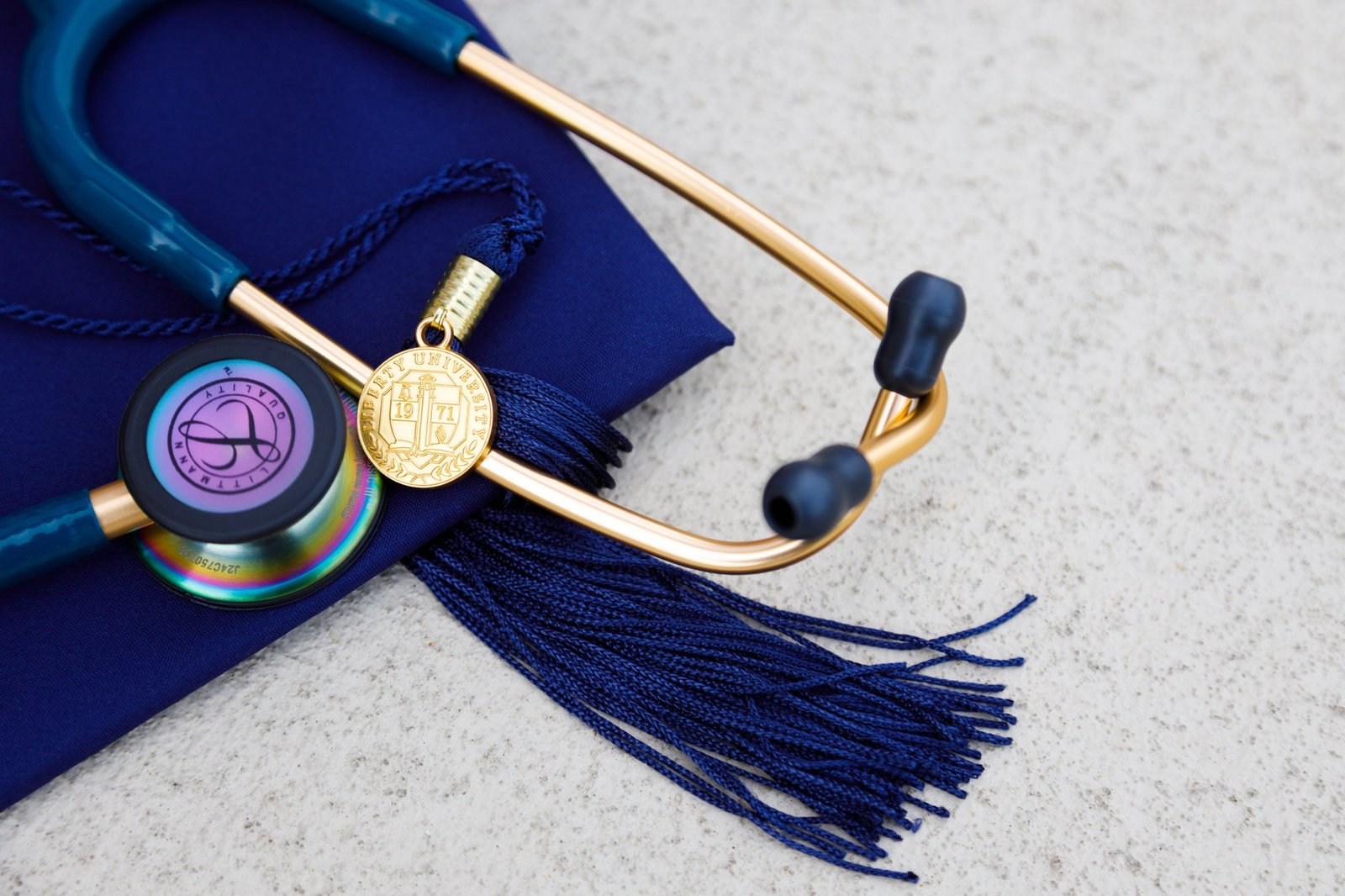 A stethoscope and medals rest on a graduation cap