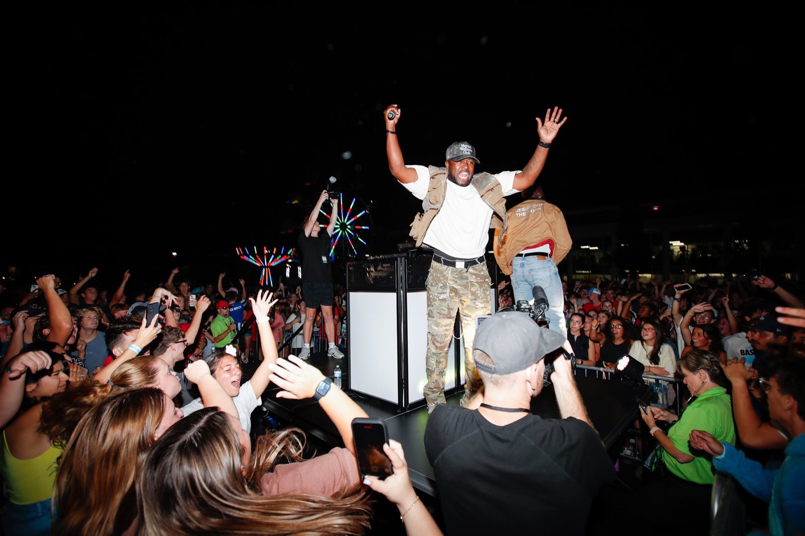 A performer raises his arms above the Block Party crowd