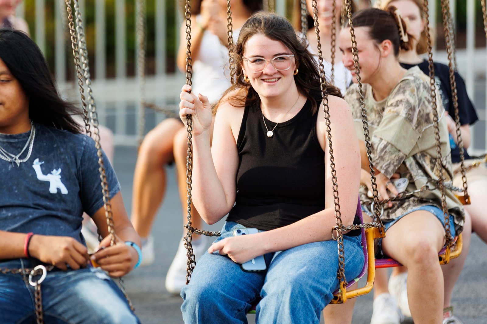 Students smile on a carnival swing ride
