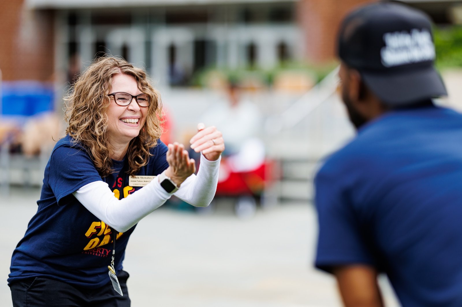 A student smiles during an outdoor campus activity