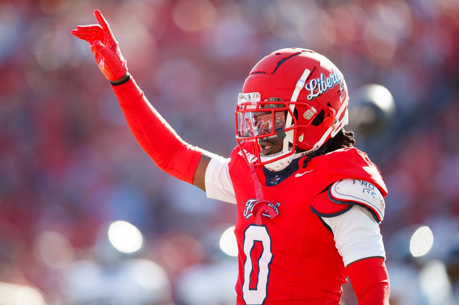 A Liberty football player gestures toward the stands