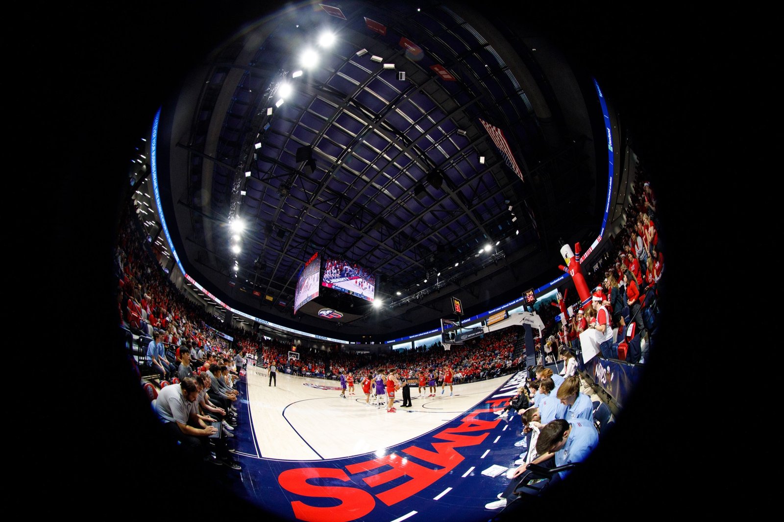 A fisheye view of a basketball game inside Liberty’s arena