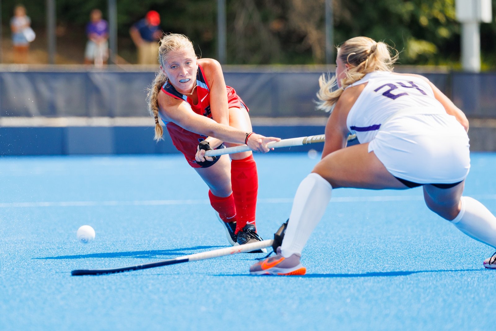 A field hockey player prepares to strike the ball